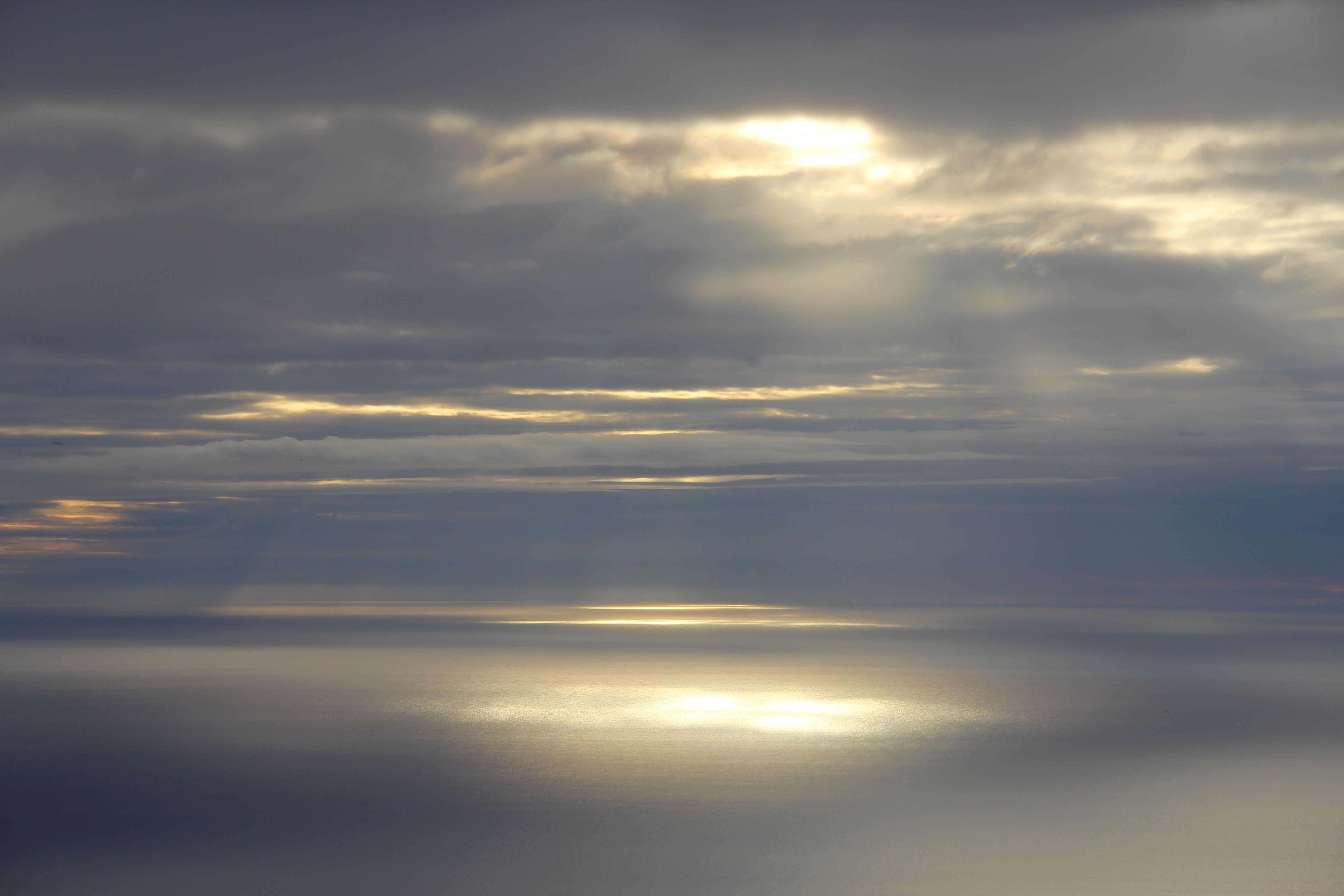 Clouds and Sunbeams over Ocean at Sunset · Free Stock Photo
