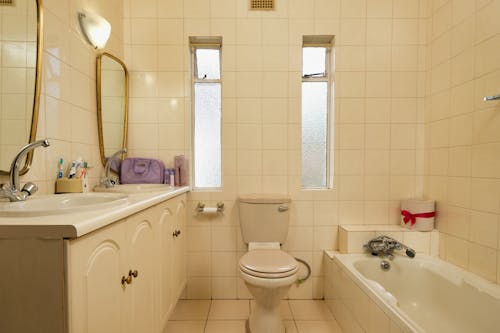 A bathroom with a toilet, sink and tub