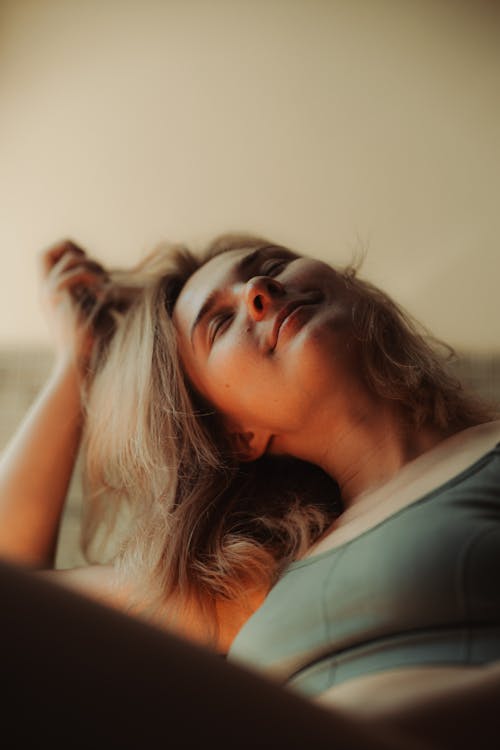 A woman laying down in a green top