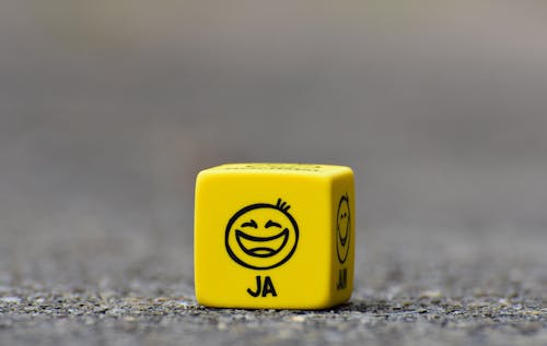 Free Yellow Cube on Brown Pavement Stock Photo