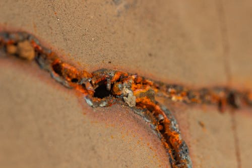 Solder mark on a brown sheet of metal