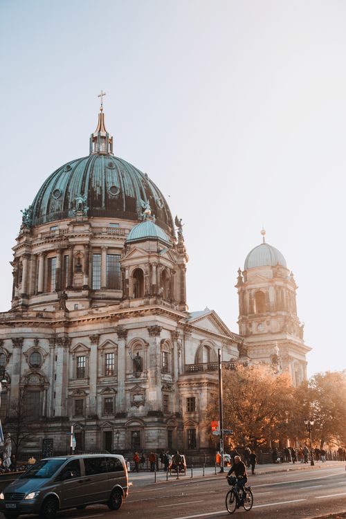Free Sunset view of Berlin Cathedral with bustling city streets, capturing urban charm and architectural beauty. Stock Photo