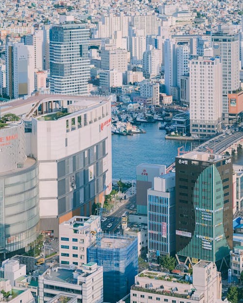 A cityscape with buildings and water in the background