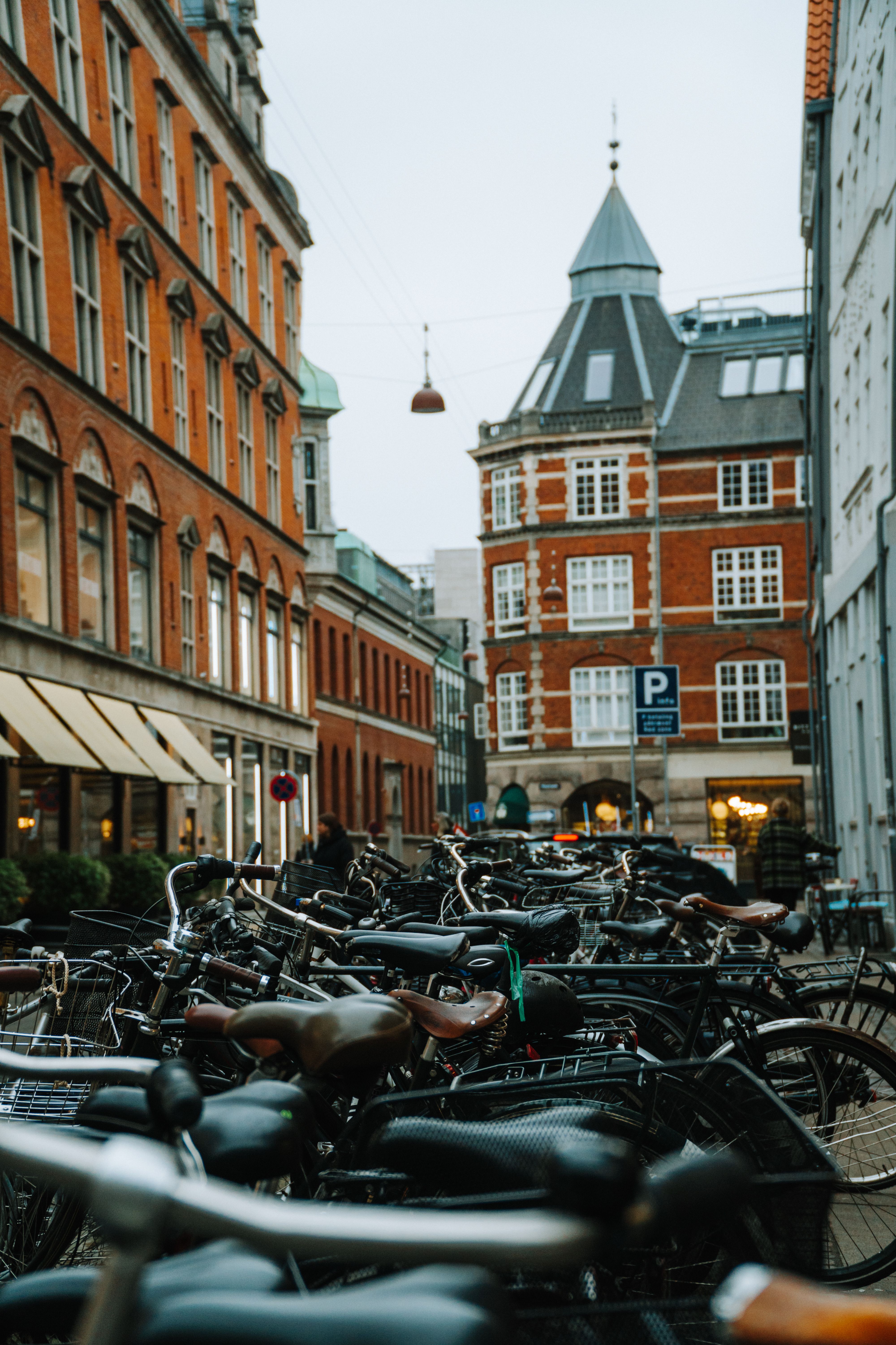 Bicycles parked along a picturesque street with historic architecture in Copenhagen, Denmark.