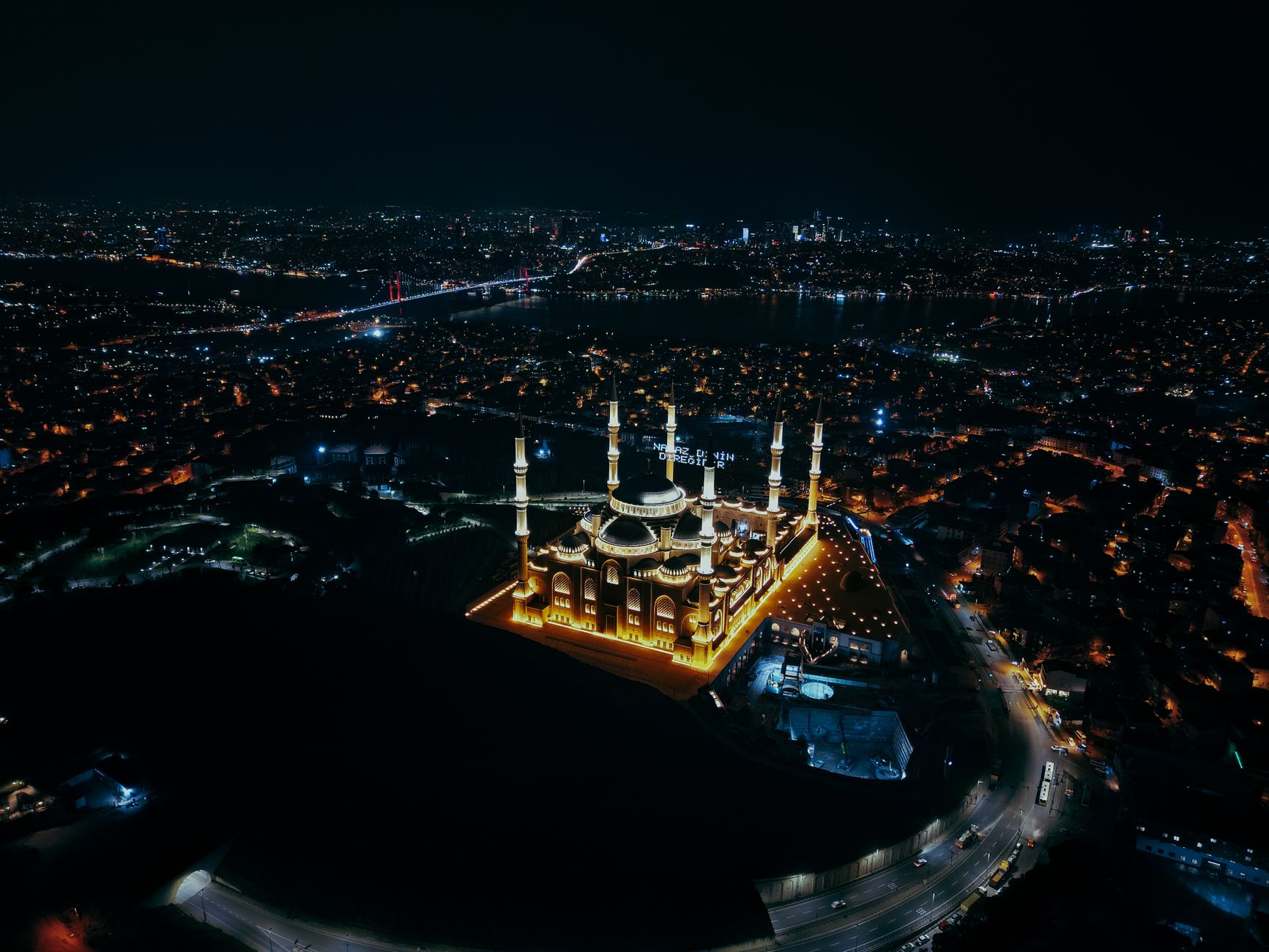 Stunning aerial night view of the Grand Camlica Mosque illuminated in Istanbul, Turkey.
