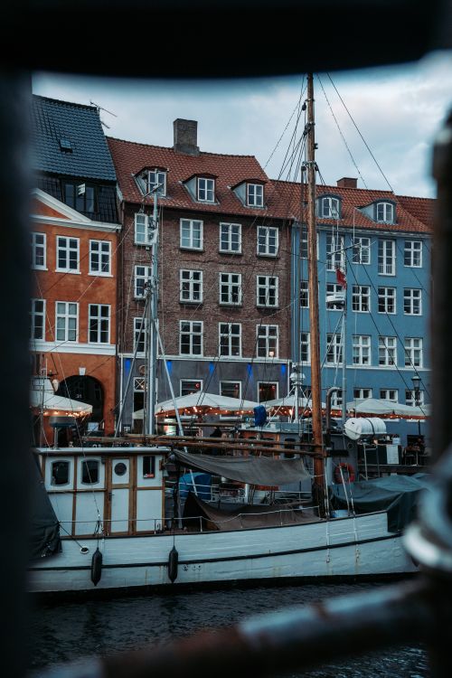 Free Charming view of Copenhagen's Nyhavn canal lined with colorful historic buildings and boats. Stock Photo