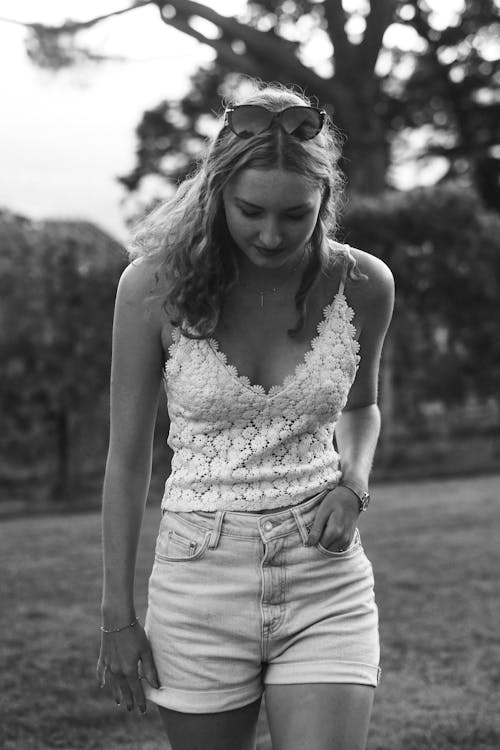 Black and White Photograph of a Blonde Wearing Shorts and a Lace Blouse