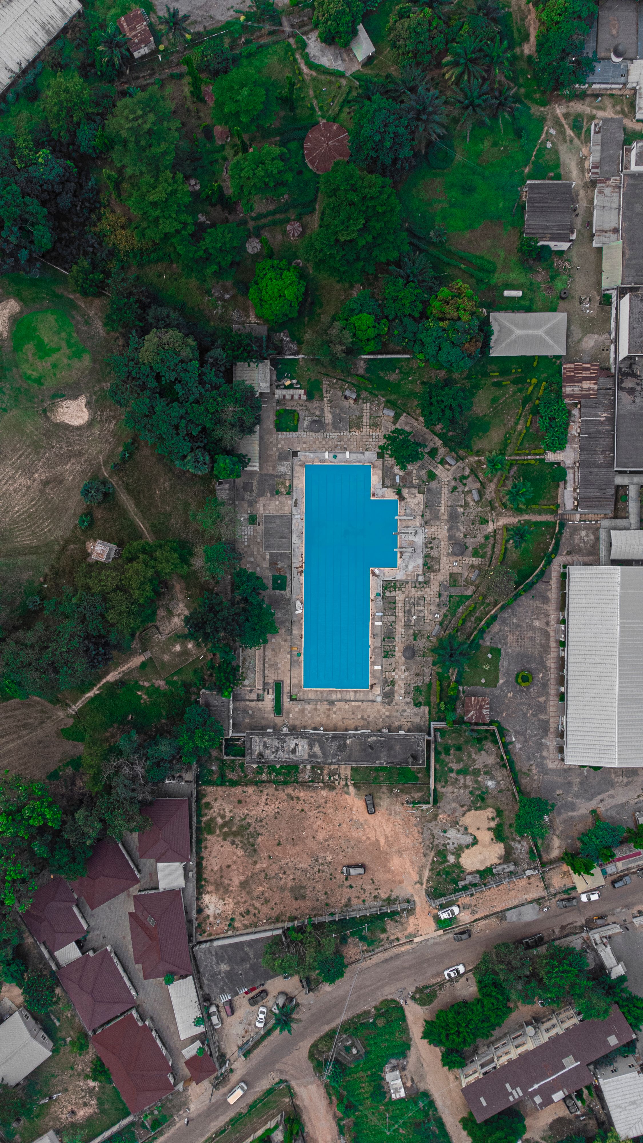 Birds Eye View on a Pool Surrounded by a Town · Free Stock Photo