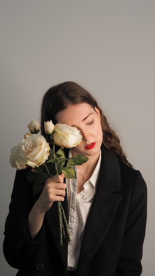 Gorgeous Woman Posing and Holding a Bouquet of Roses