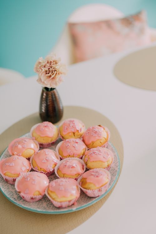Free A plate of cupcakes with pink frosting on a table, perfect for dessert enthusiasts. Stock Photo