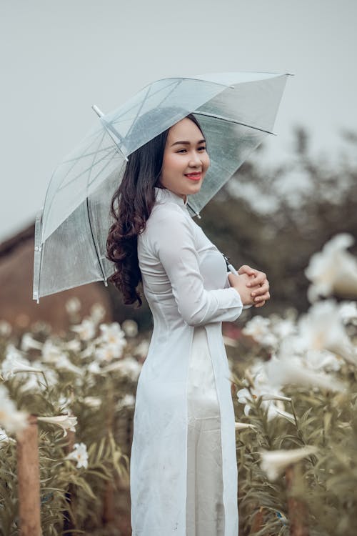 Woman in White Dress Holding Umbrella