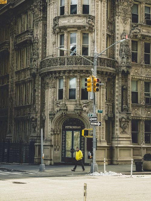 A person walking down the street in front of a building