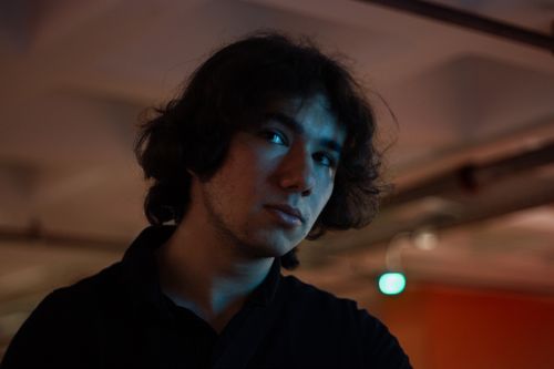 Free Captivating moody portrait of a young man in an urban setting at night. Stock Photo