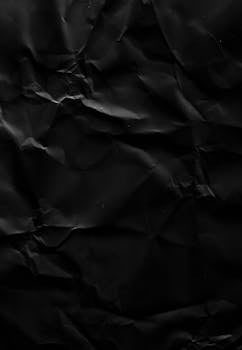 High-resolution crumpled black paper texture perfect for overlays and backgrounds.