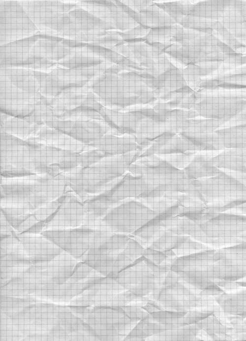 A sheet of crumpled paper with a grid pattern