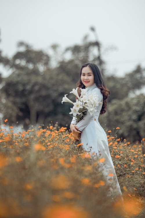 Woman Holding White Flowers