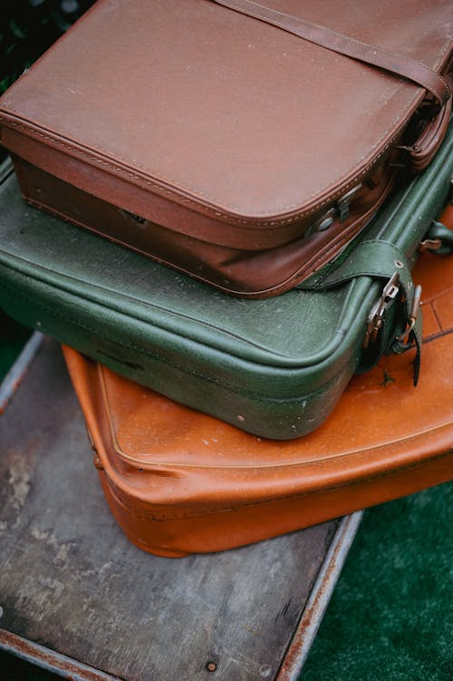 A stack of suitcases on a green table