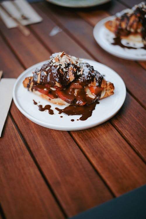 A dessert with chocolate sauce and nuts on a plate