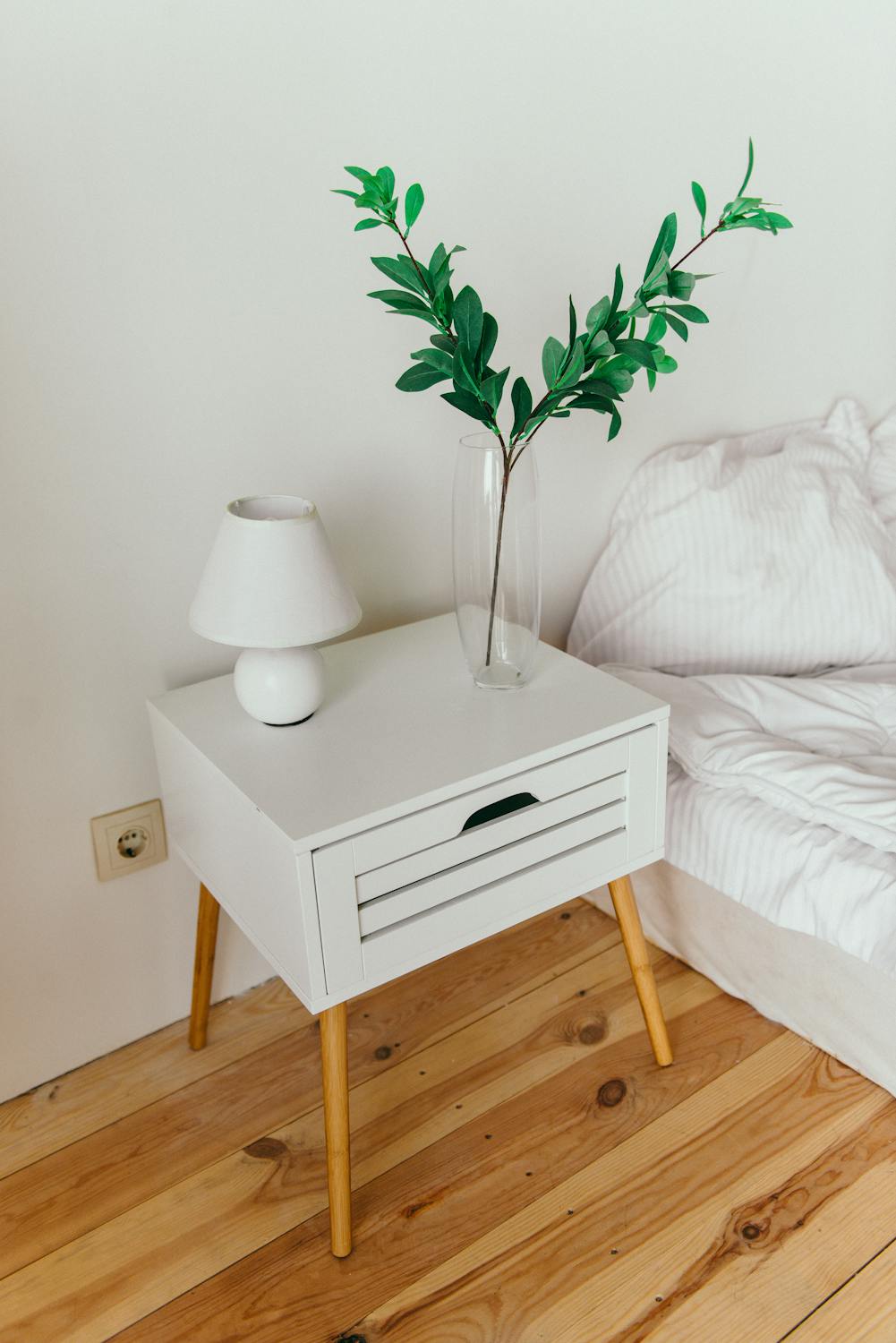 Lamp standing on the self next to bed in feng shui bedroom