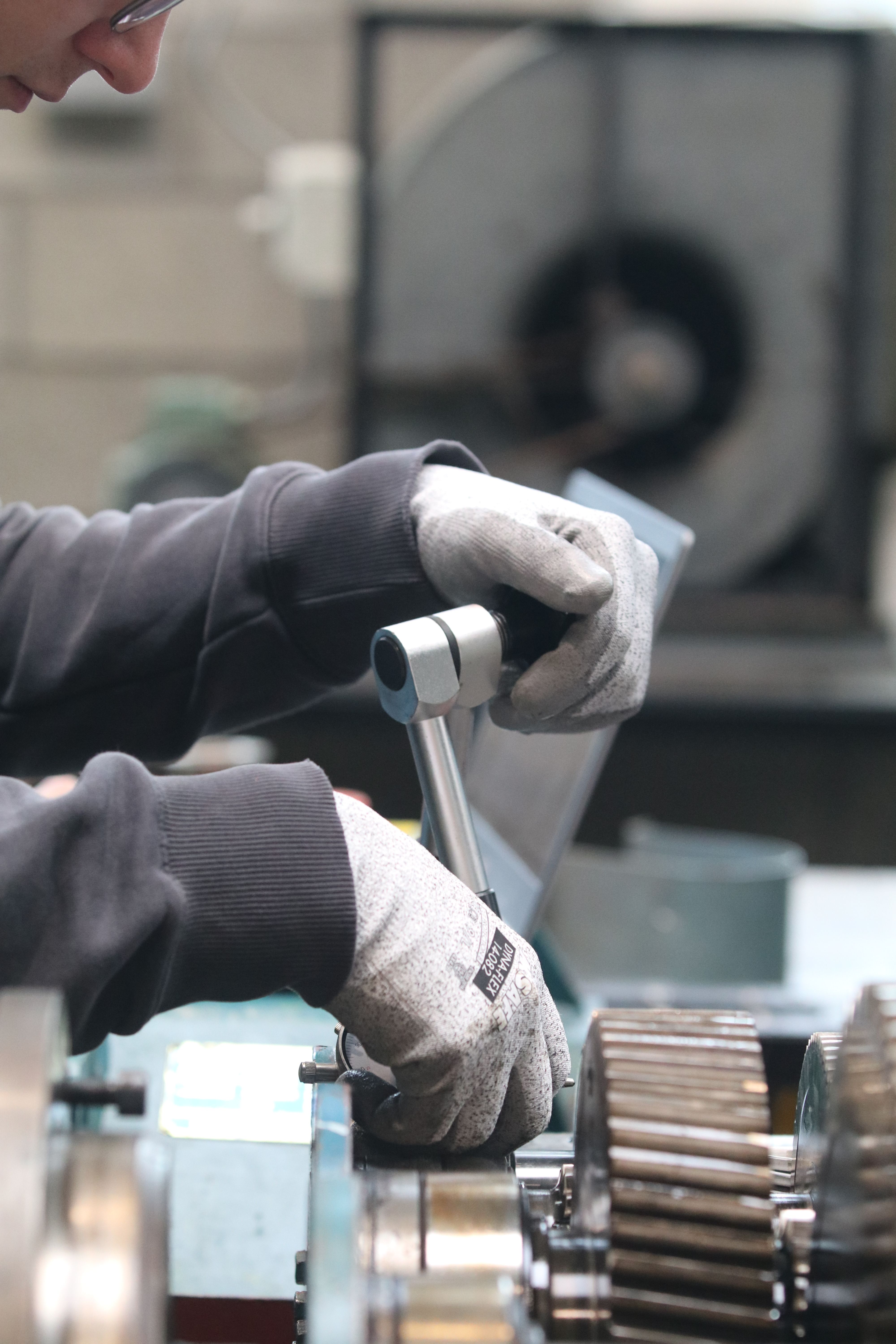 Close-up of a Man Using a Tool in a Workshop · Free Stock Photo