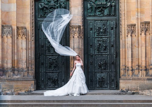 Free Woman Wearing Wedding Dress Standing Near Closed Doors Stock Photo