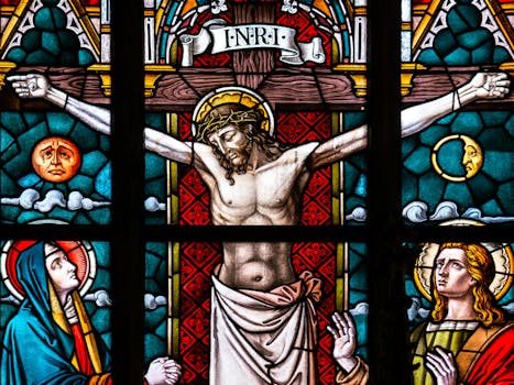 Detailed stained glass depiction of the crucifixion featuring Christ and religious icons.