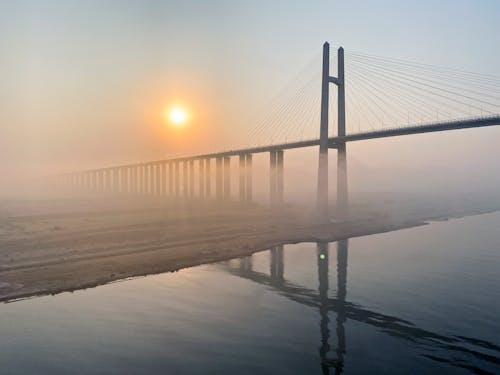 A bridge over a river with fog in the background