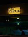 Say Cheese Text on Wall in Darkness