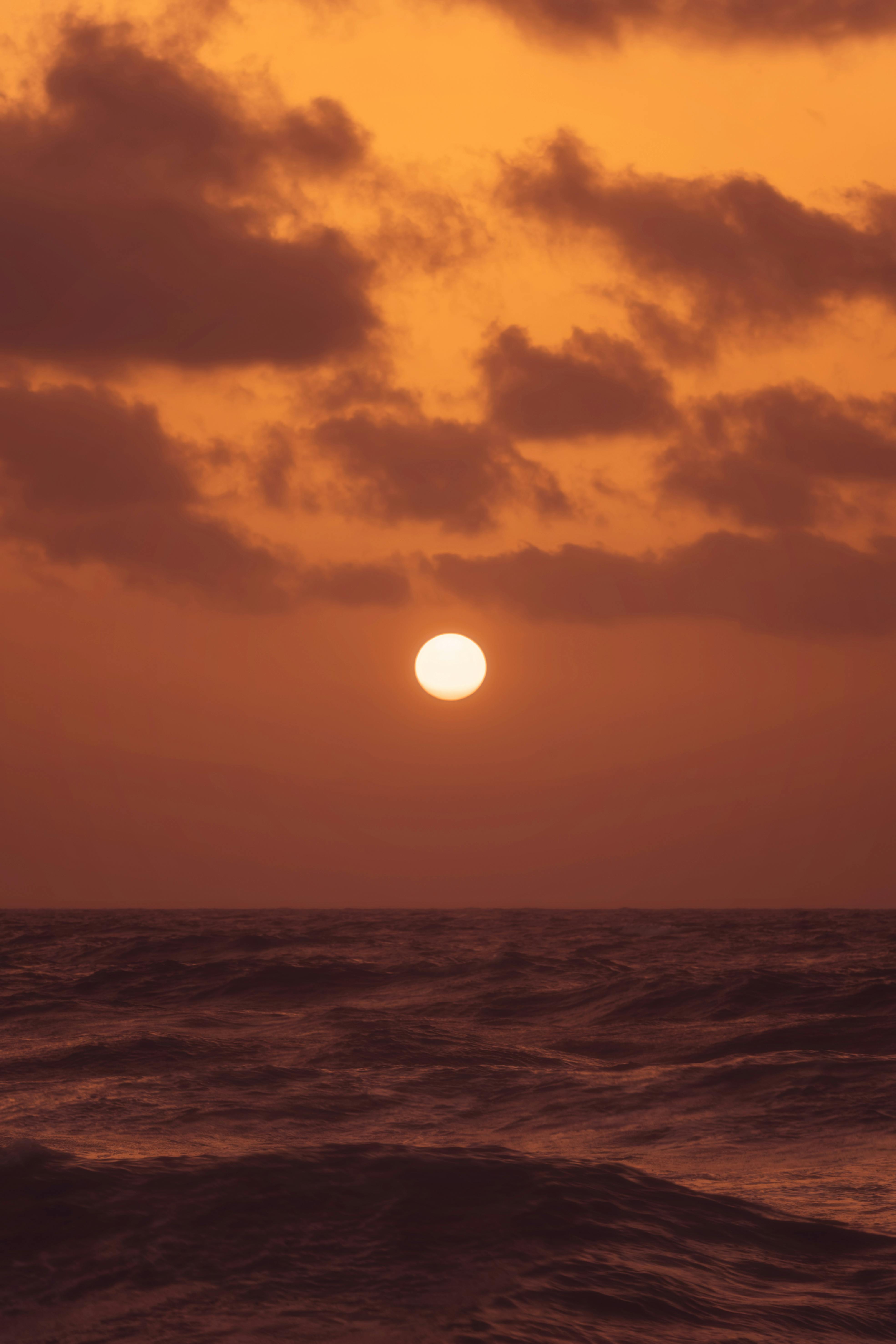 A stunning sunset over Akumal's ocean, capturing vivid hues and tranquil waves.