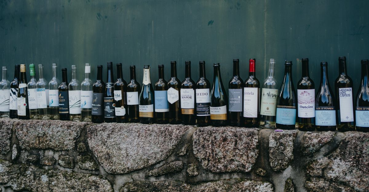 Row of Bottles of Wine on Wall · Free Stock Photo