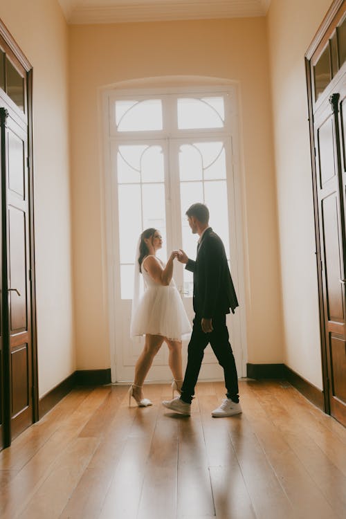 A couple dancing in an empty hallway