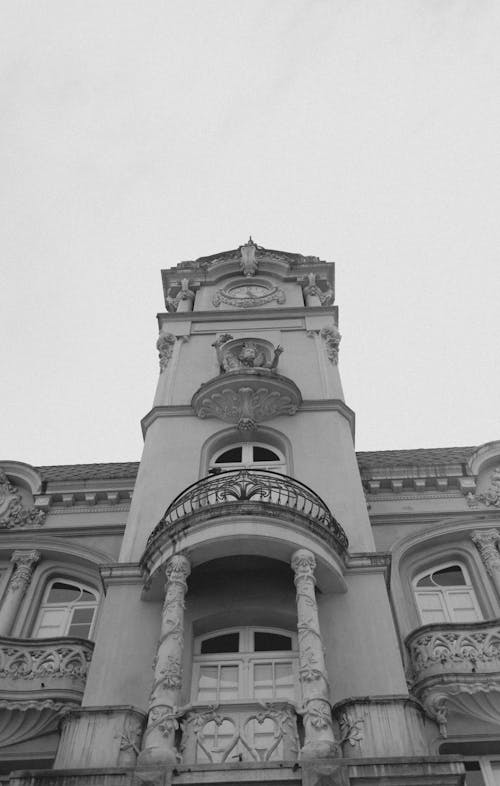 A black and white photo of a building with a clock