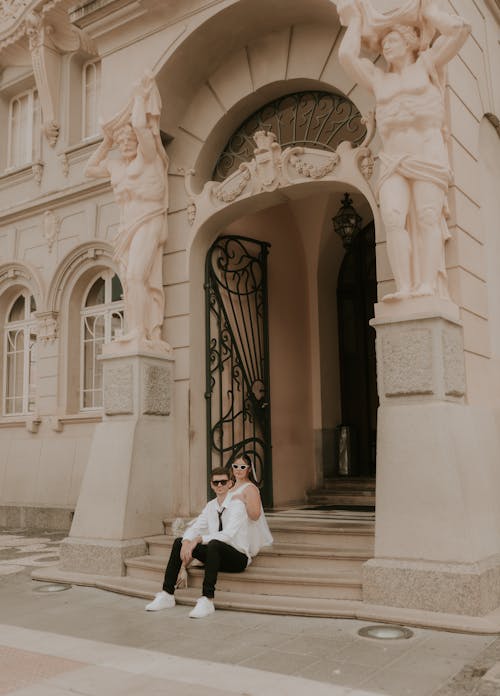 A woman sitting on the steps of a building