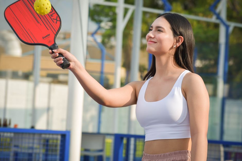 outdoor pickleball play on a sunny court with neon green balls - best pickleballs to buy outdoor pickleball play on a sunny court with neon green balls - best pickleballs to buy