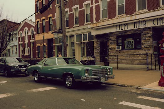 Classic Chevrolet Monte Carlo parked on a vintage city street with nostalgic architecture.