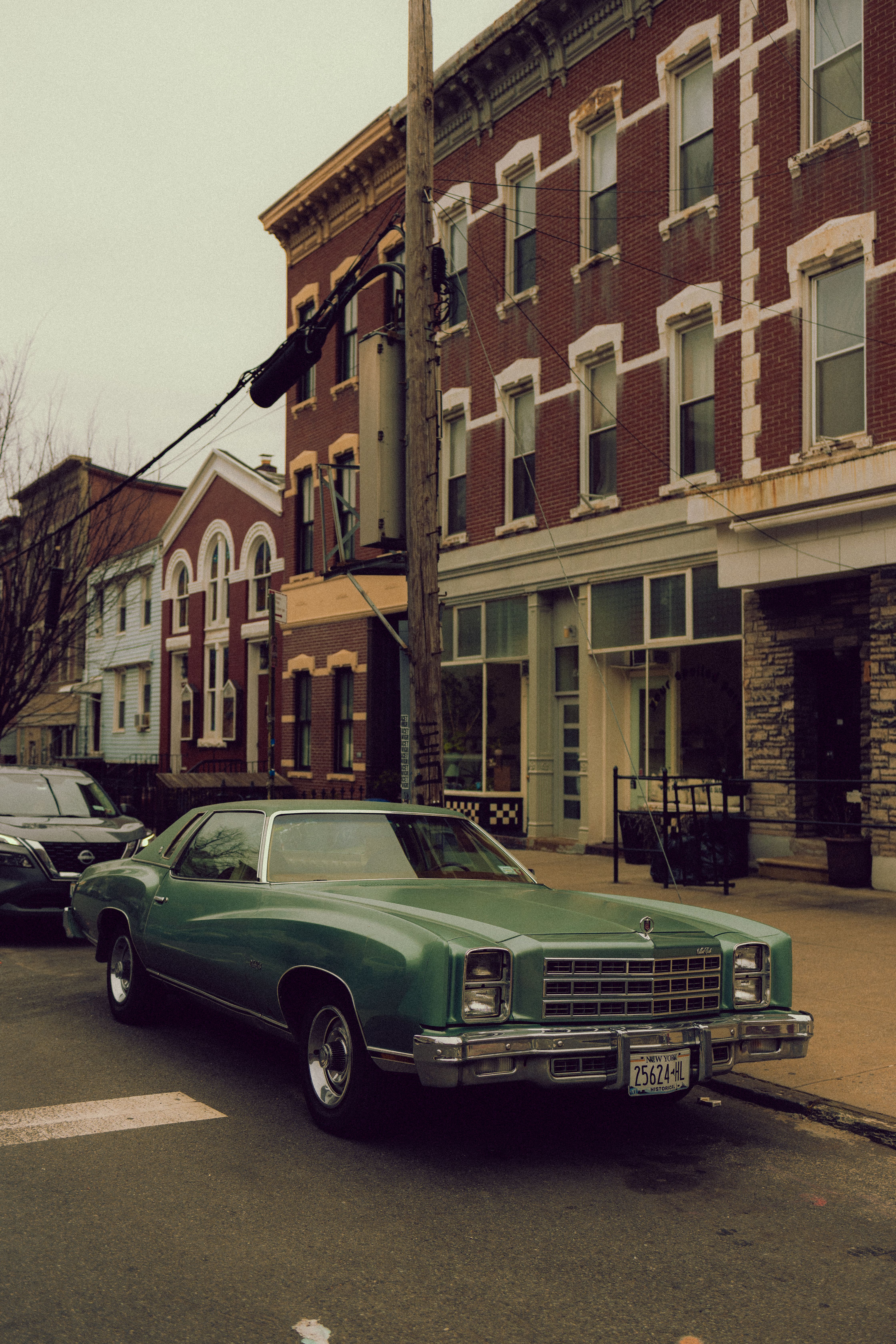 A green car parked on the side of the road · Free Stock Photo