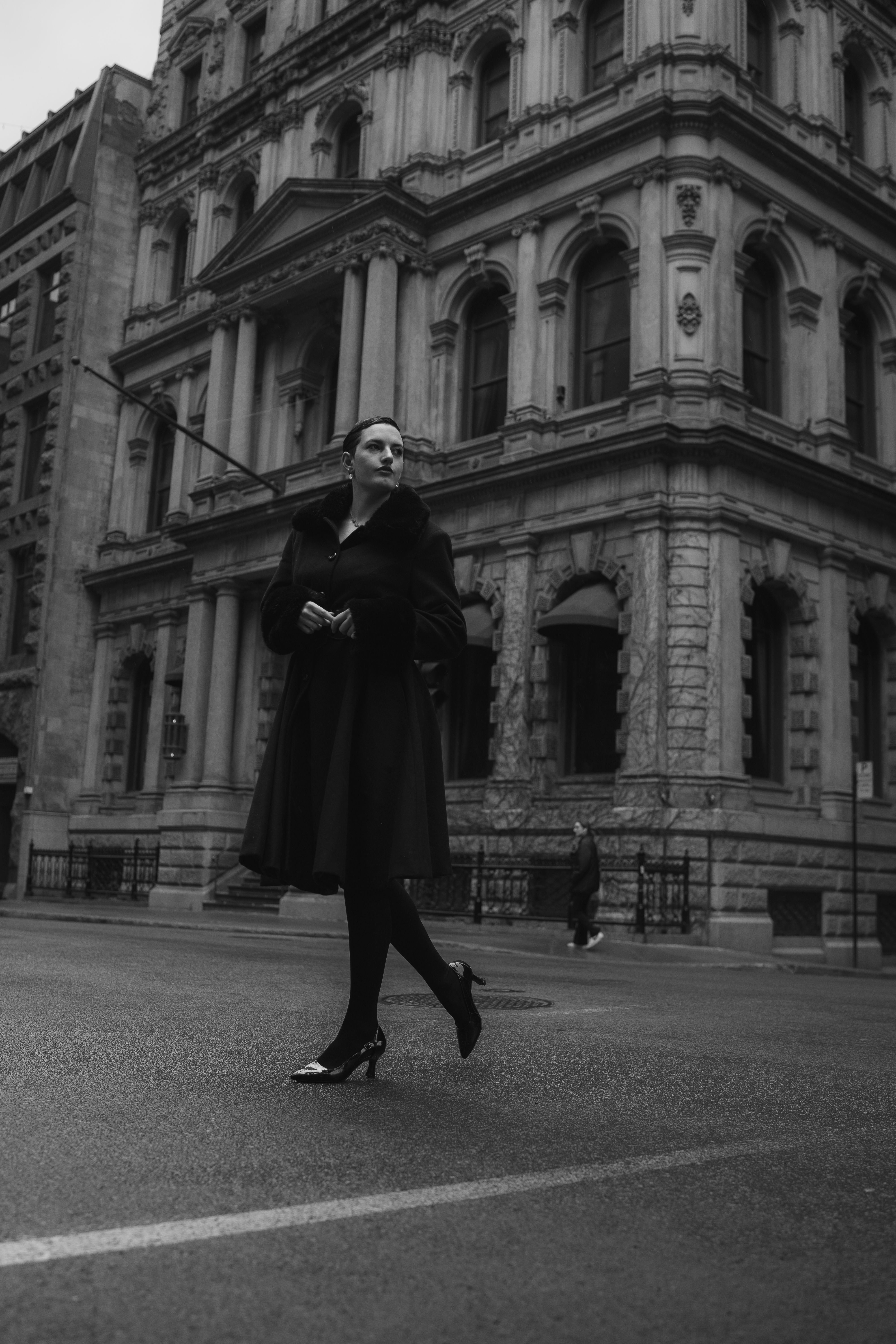 A woman in black and white is walking down the street · Free Stock Photo