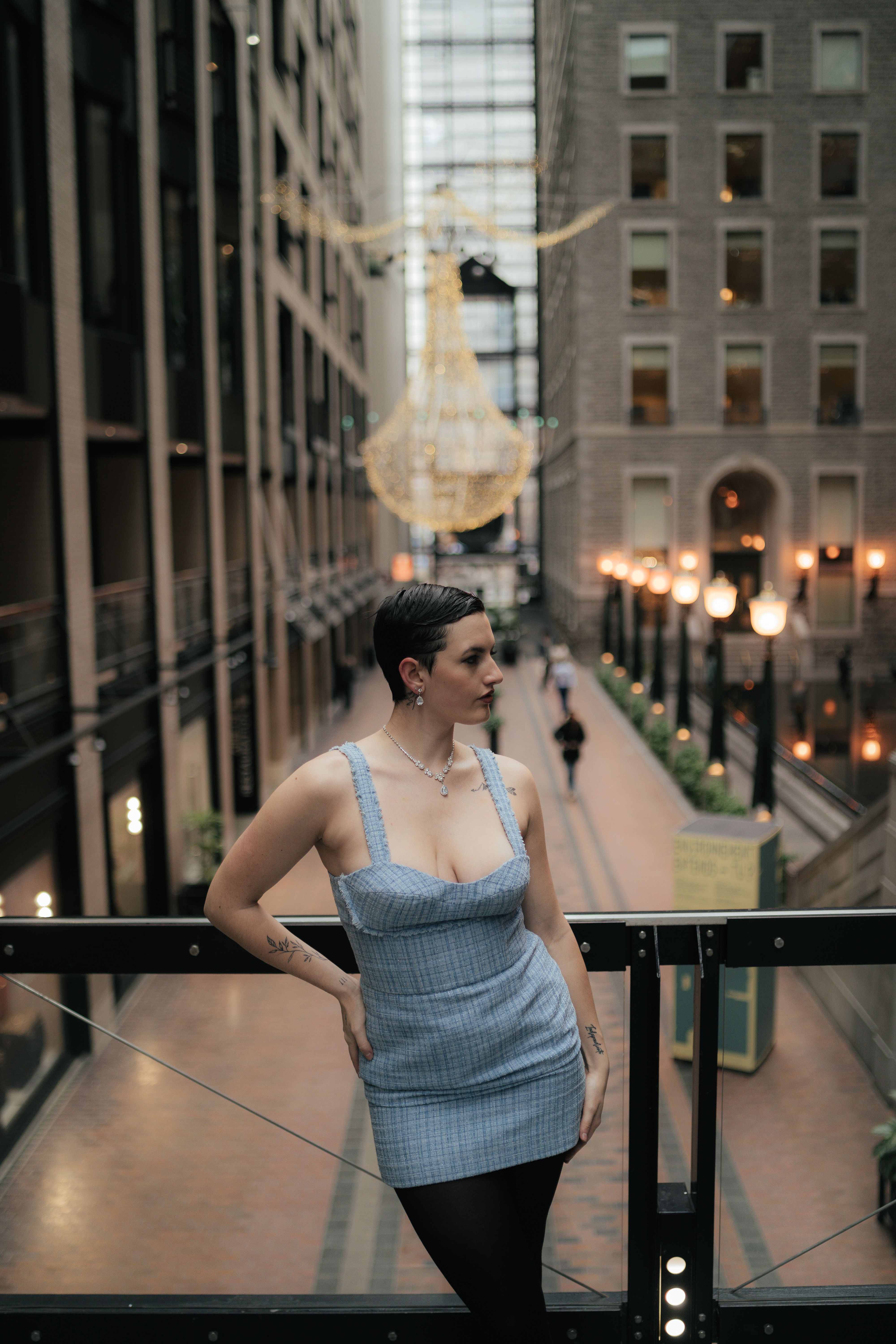 A woman in a blue dress standing on a balcony · Free Stock Photo