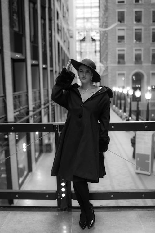 Black and white photo of woman in hat and coat