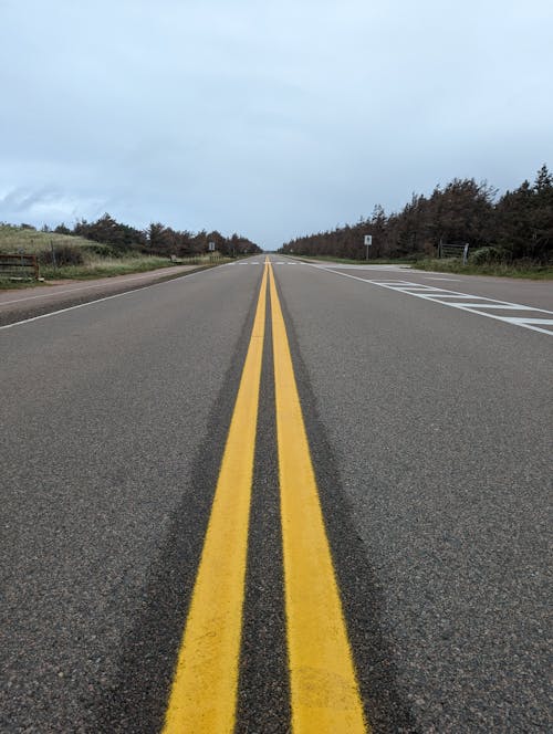 A long empty highway with yellow lines