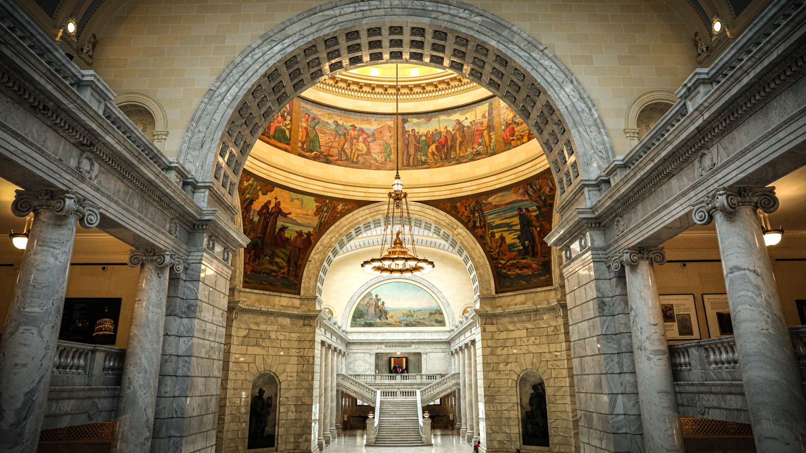 Stunning interior view showcasing marble columns and intricate murals at Utah State Capitol.