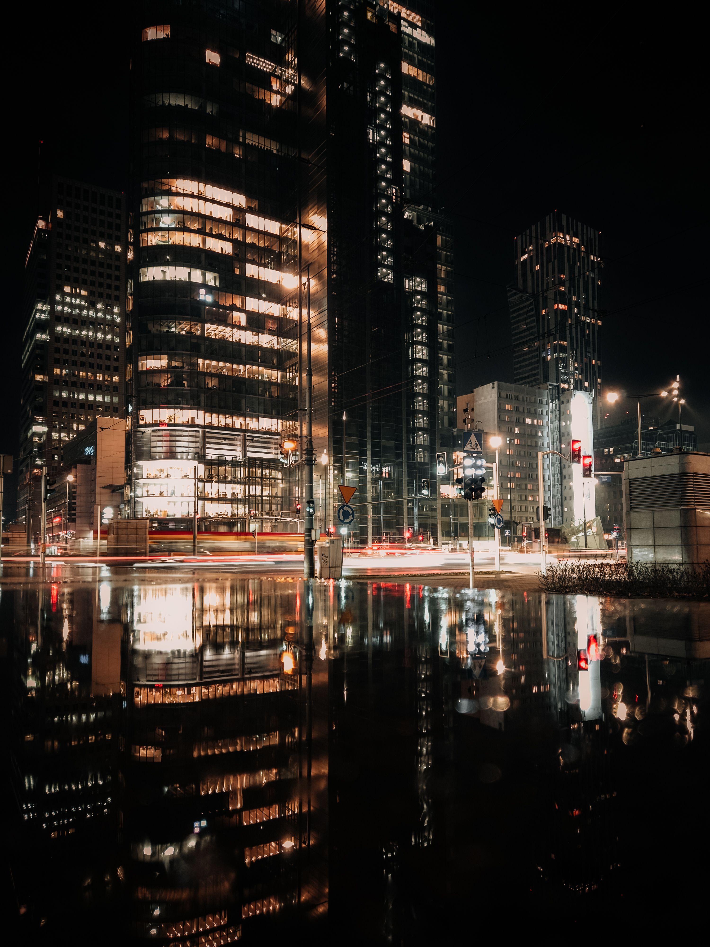 A city at night with reflections in the water · Free Stock Photo