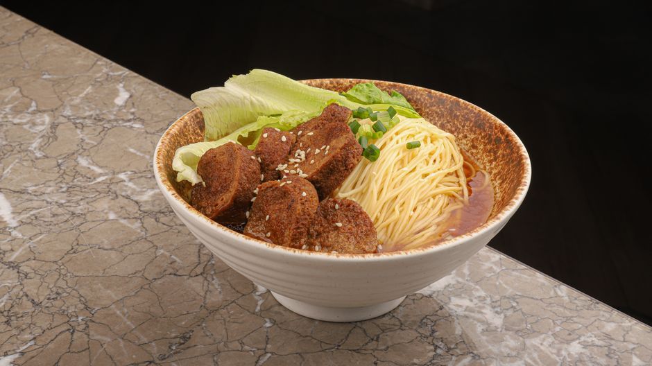 A steaming bowl of authentic Taiwanese beef noodle soup with tender beef and rich broth.
