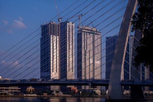 A bridge over a river with tall buildings in the background