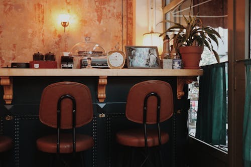 A bar with two chairs and a table