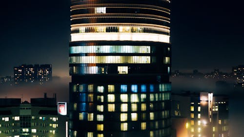 A tall building with lights on it at night