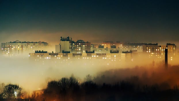 Misty night view of residential buildings shrouded in fog in Saint Petersburg, Russia.