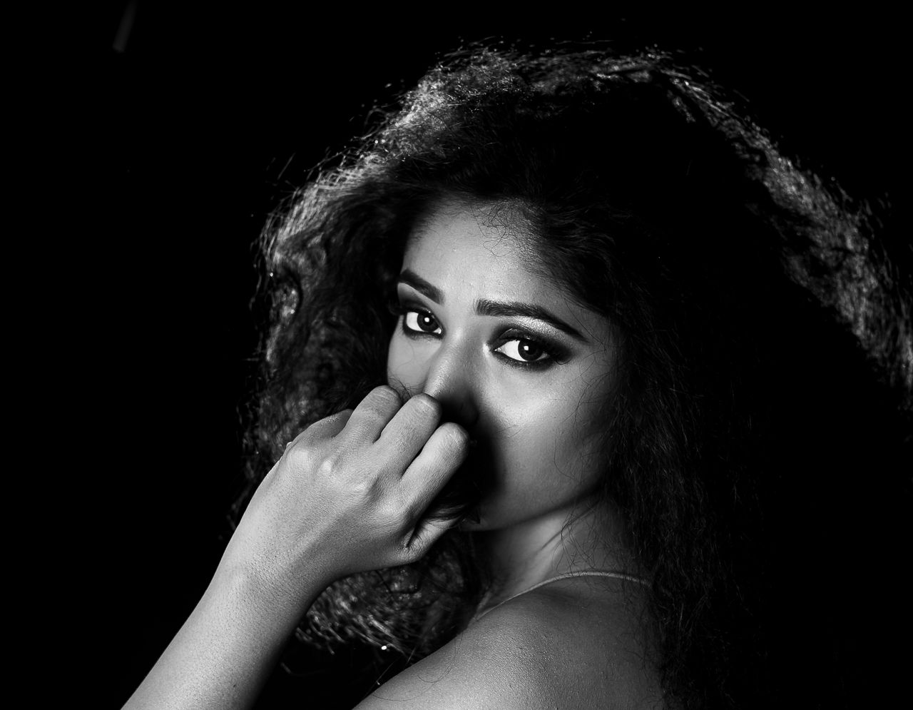 striking black and white portrait of a woman with expressive eyes and