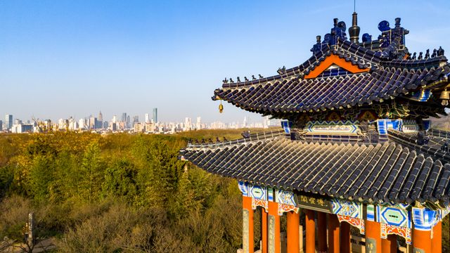 Scenic view of a traditional Chinese pavilion with the Nanjing city skyline in the background. — lounges at Nanjing Airport