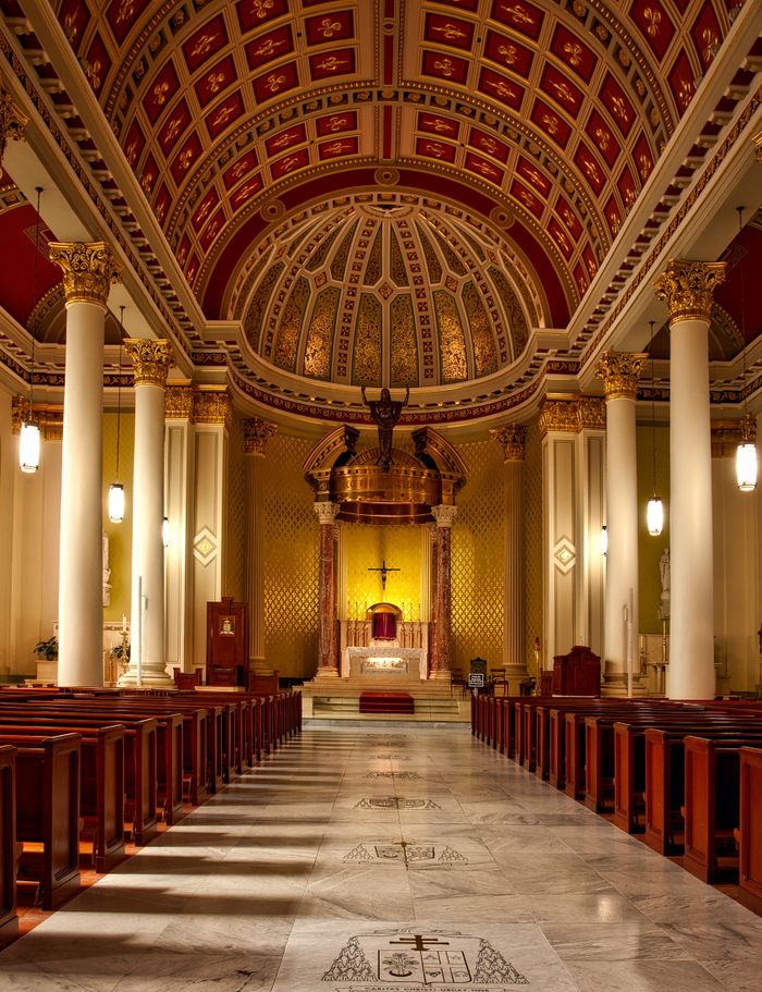 Light through tall stained glass inside a cathedral, a peaceful setting for people exploring free Catholic dating sites